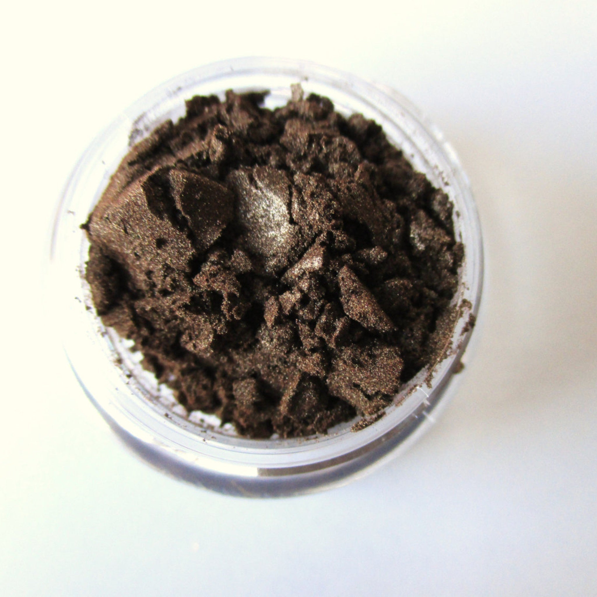 Close-up of vegan mocha mineral eye shadow in compact with smooth matte finish and warm brown tones