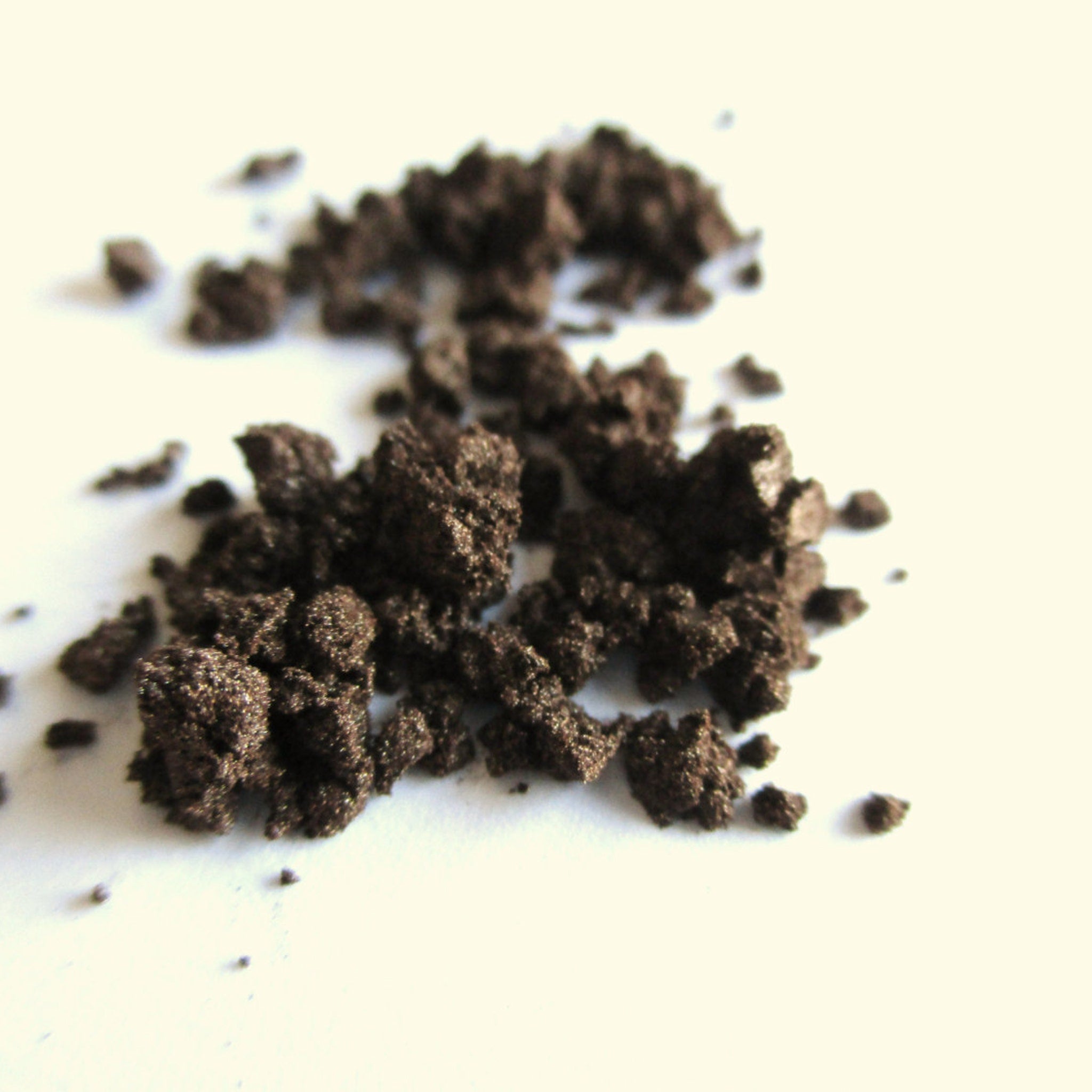 Side view of vegan mocha mineral eye shadow pot showing rich brown powder texture and compact size