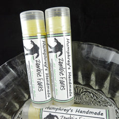 Lip balm tubes with white labels, green stripes, and clear plastic caps; "Humphrey's Handmade Zombie Farts" text visible