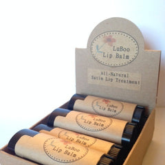 Lip balm tubes in a display box, with LuBoo brand label, brown paper wrap, and black caps