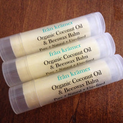 Lip balm tubes with white and clear plastic, cream colored balm, and "från krämer" text on label