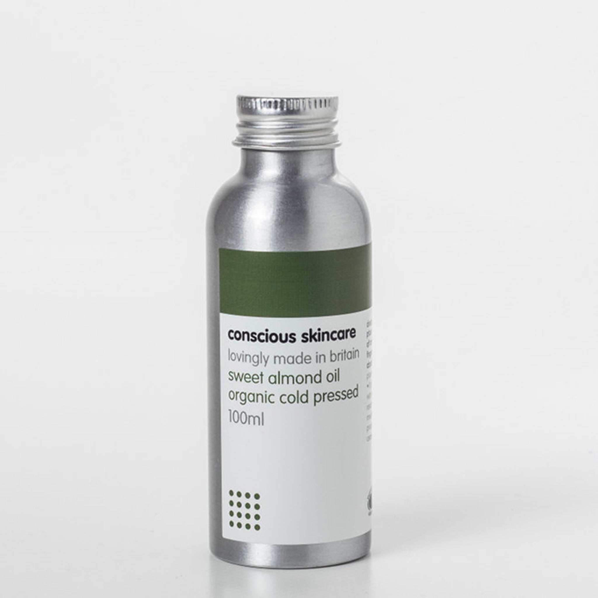 Sweet almond oil in silver metal bottle with green and white label, Conscious Skincare brand