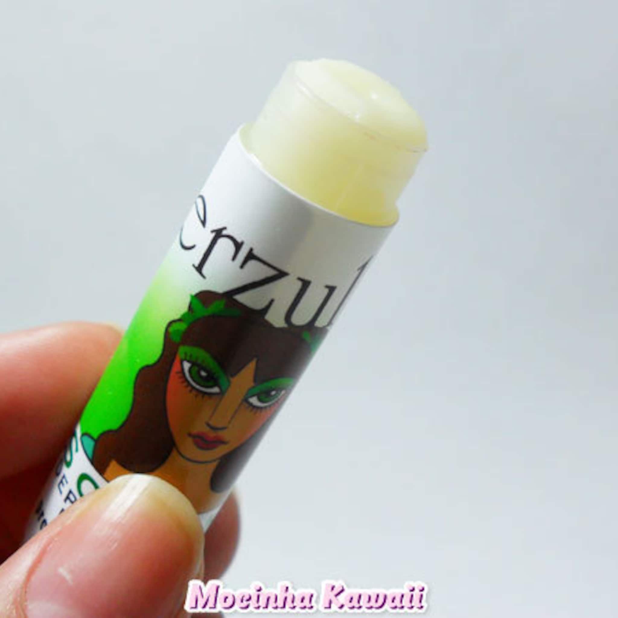 Lip balm with green and white tube, "erzul" text, and yellow balm visible