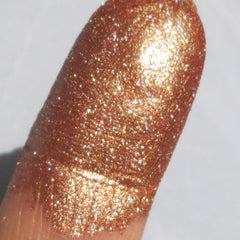 Side view of bronze and golden mineral eye shadow palette showing shimmer texture and compact size