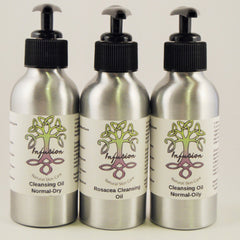Cleansing oil bottles with black pump tops and silver metal bodies, Infusion brand visible