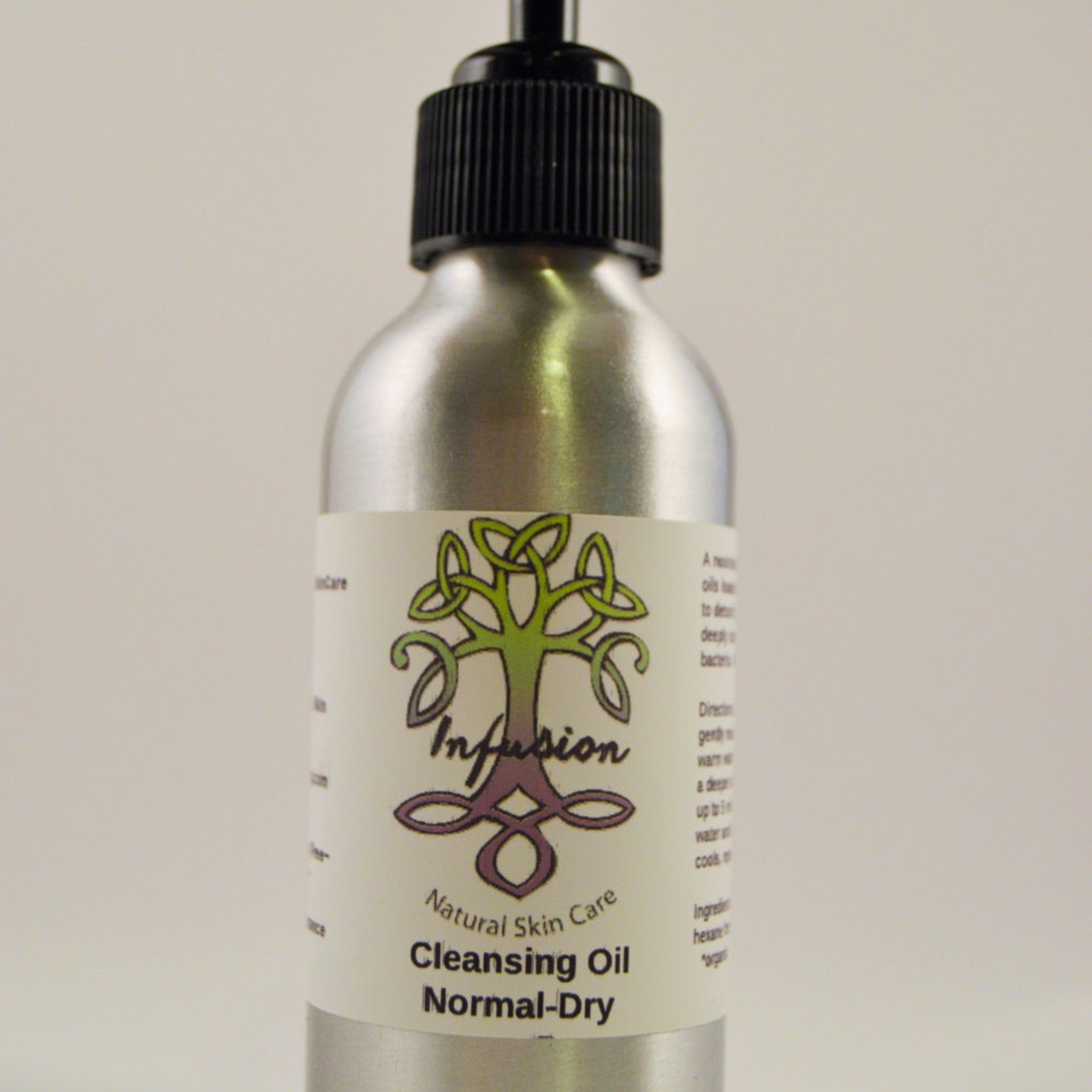 Cleansing Oil bottle with silver metal, black cap, and white label with "Infusion" text