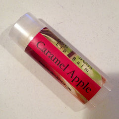 Lip balm tube with red label, "Caramel Apple" text, and clear plastic casing
