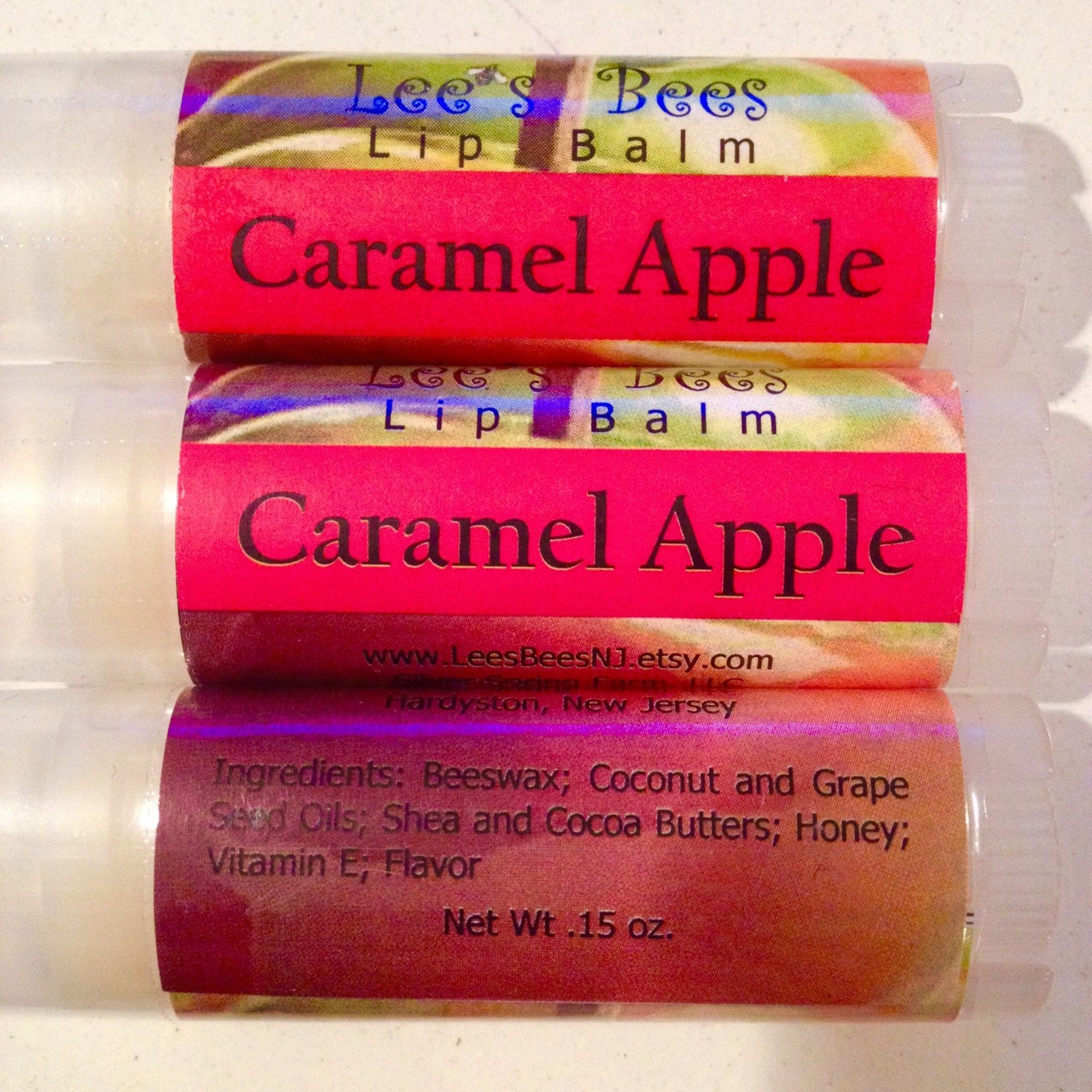 Lip balm tubes with red and patterned labels, "Caramel Apple" flavor, Lee's Bees brand