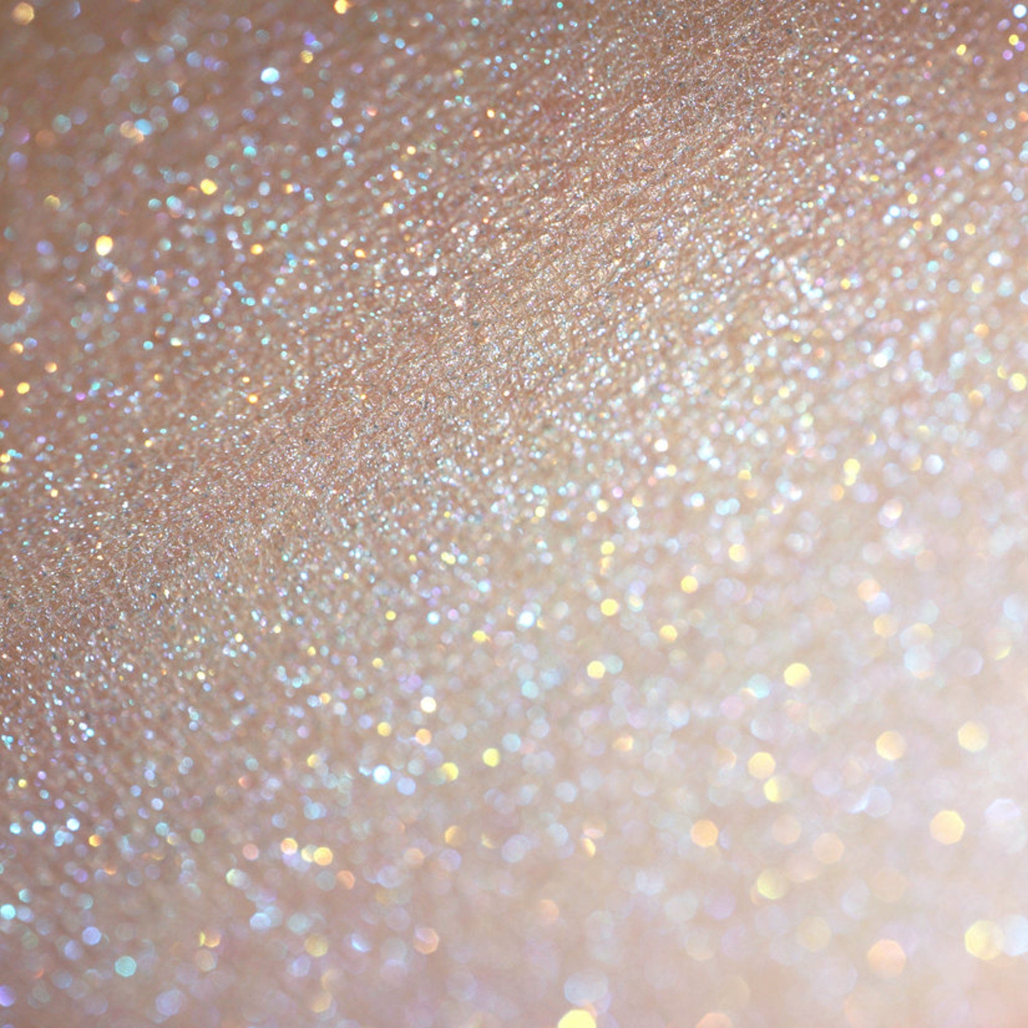 Side view of La Sirena Aqua Eye Shadow duo showing turquoise and orange iridescent shimmer in compact case