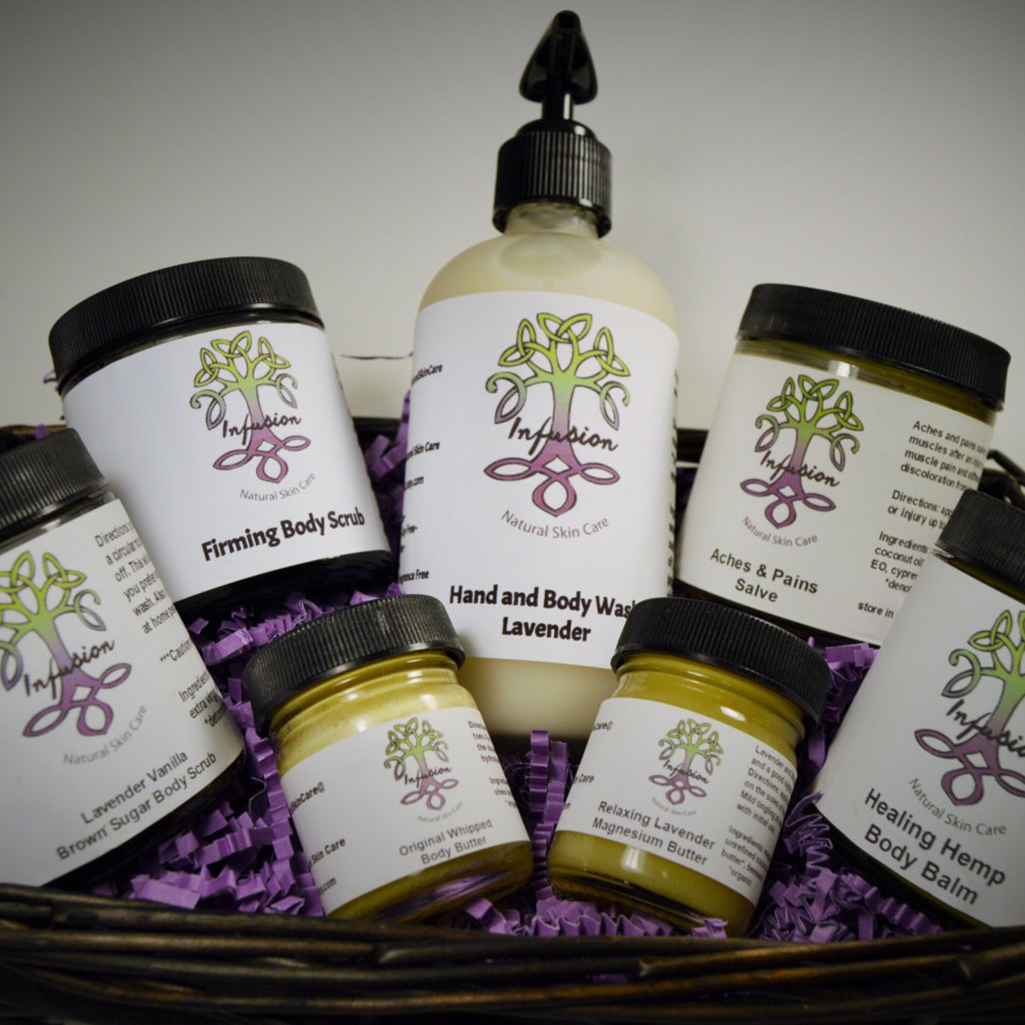 Body care products in a basket with black lids, white labels, and purple filler