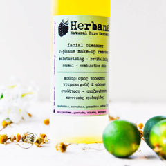 Facial cleanser bottle with yellow liquid, green and white label, Herbana brand name visible