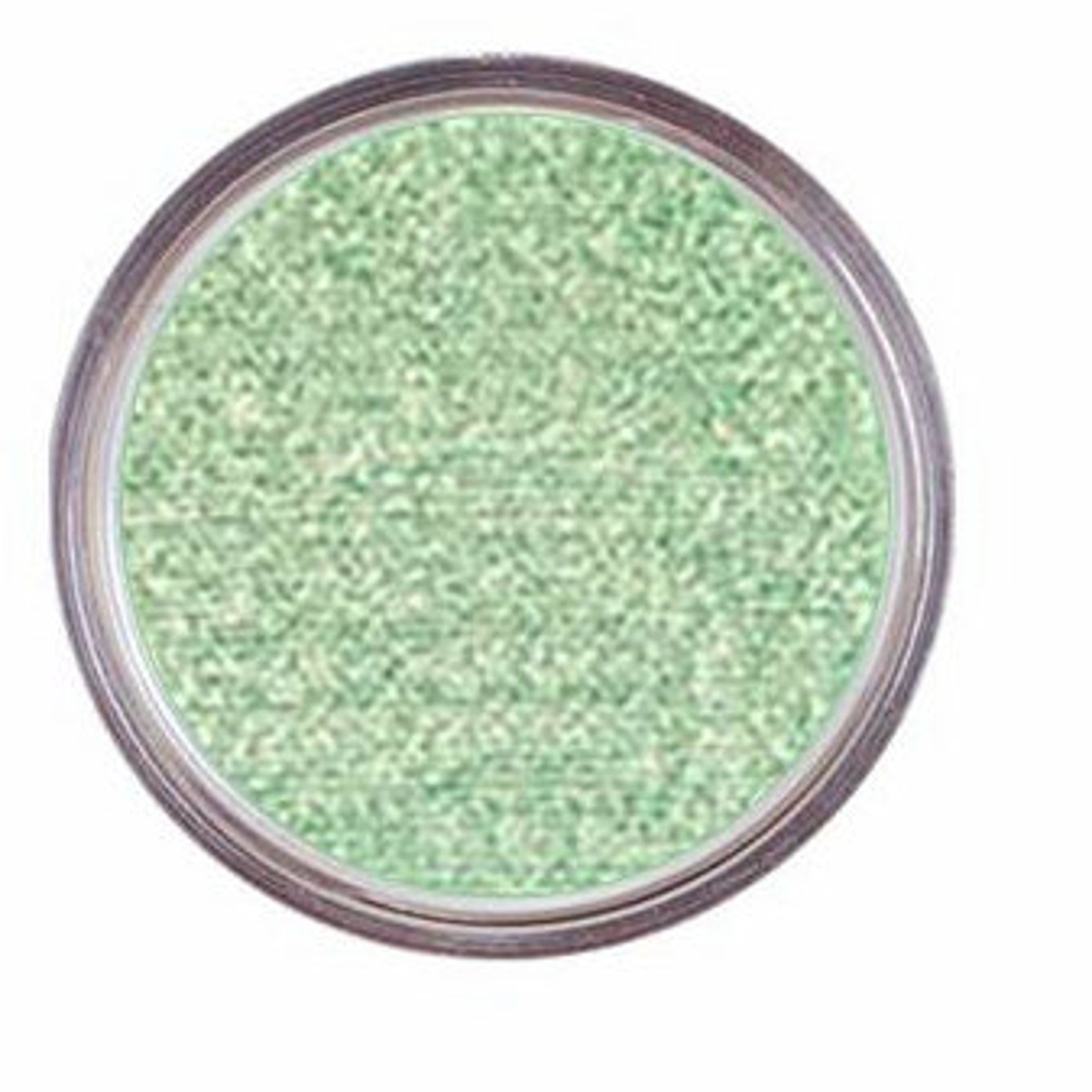 Extreme close-up of iridescent mint green holographic eye shadow showing sparkling pigment particles