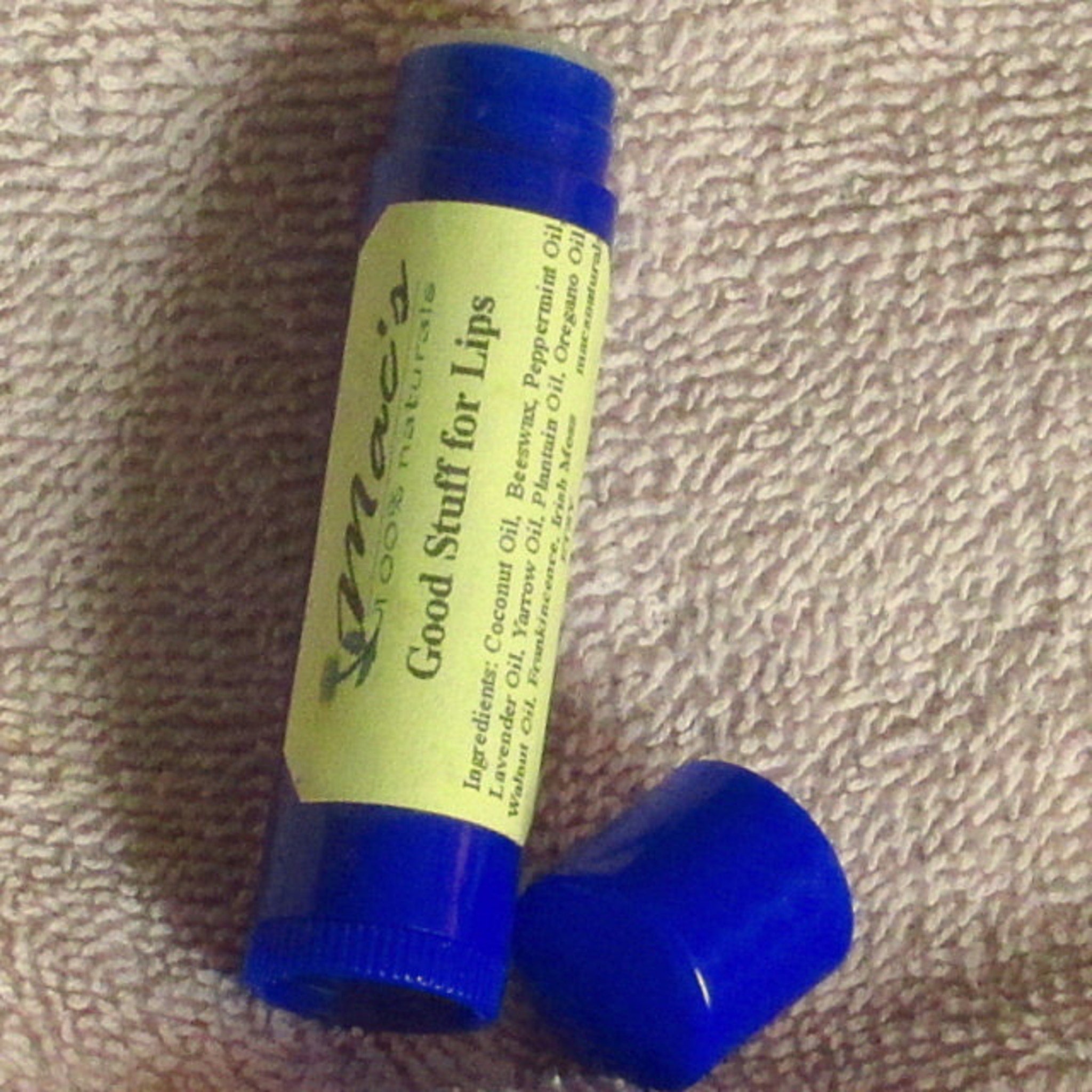 Lip balm stick with blue plastic tube and cap, yellow label, and text "Good Stuff for Lips