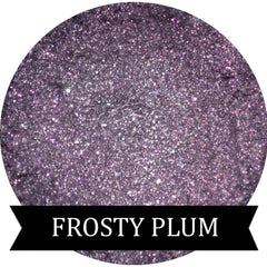Close-up of shimmery frosty plum purple eyeshadow in a compact pan with reflective metallic finish