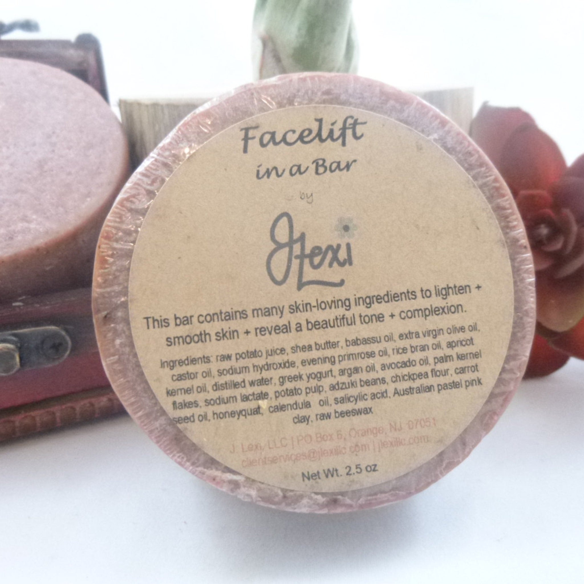 Soap bar wrapped in clear plastic with J Lexi label, pink color, round shape
