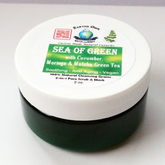 Face scrub jar with white lid, green label, and dark green jar, Earths Own brand