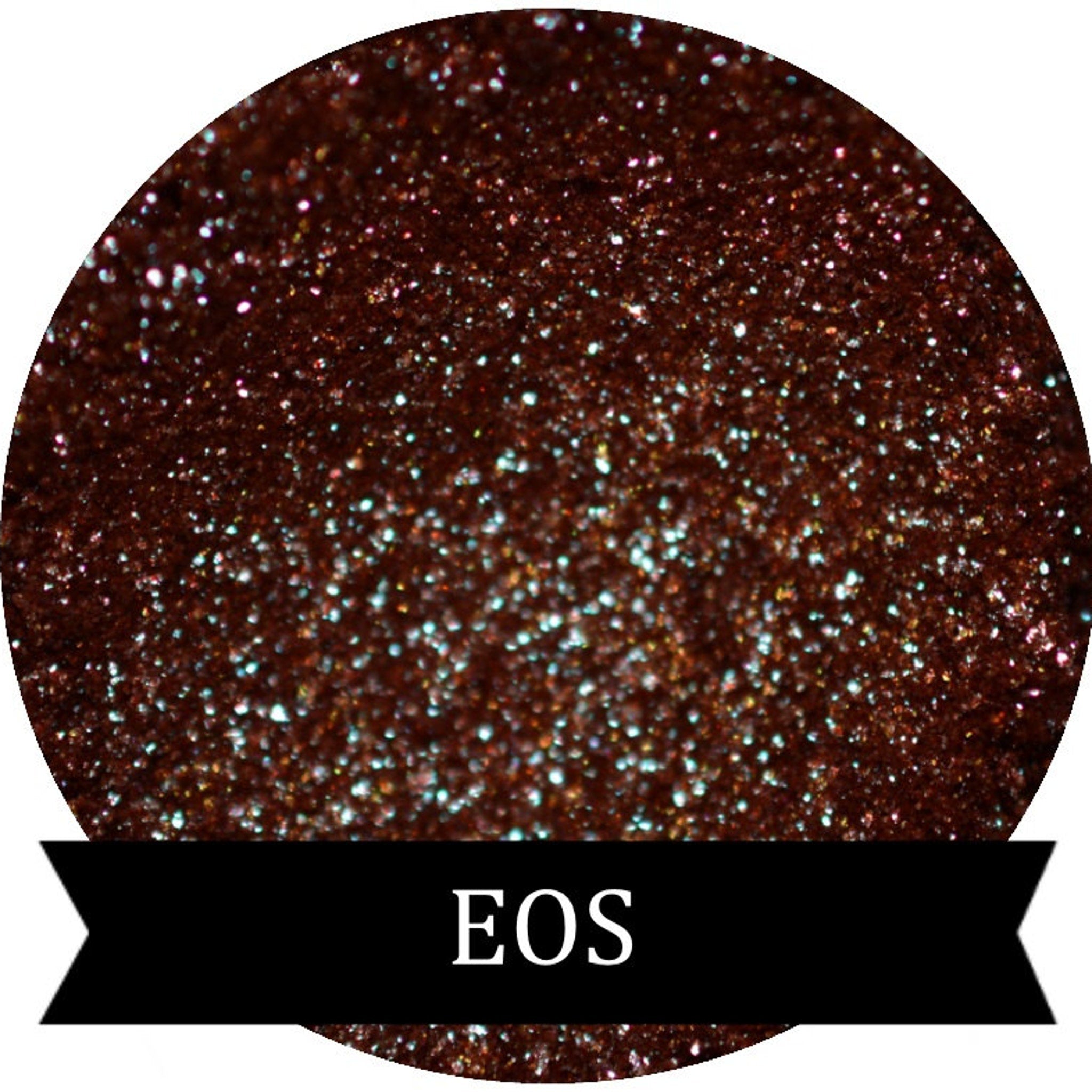 Close-up of duochrome eyeshadow pigment pots in brown, red, green, and blue with metallic sheen