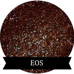 Close-up of duochrome eyeshadow pigment pots in brown, red, green, and blue with metallic sheen