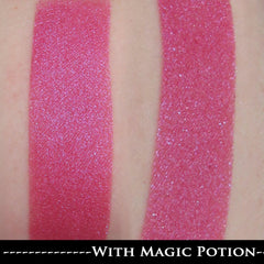 Close-up of fingertips applying cool pink and purple duochrome shimmer eyeshadow with soft blending brush