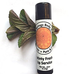 Lip balm tube with black cap, white label, and green leaves, "Minty Fresh Lip Service" text