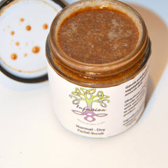 Facial scrub in glass jar with brown contents and white label, "Infusion" brand visible